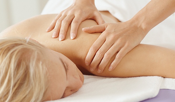 Woman Having Shoulder Massaged-Therapeutic Massage for Women-Dona Baba-Wichita, KS